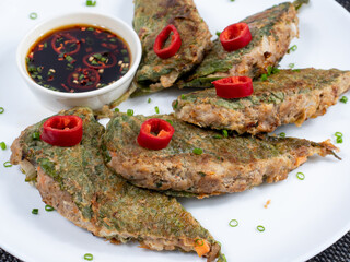 Korean food : Kkaennipjeon. Half-folded perilla leaves stuffed with a mixture of minced meat and vegetables, egg-battered, and pan-fried.  Korean ritual food usually eaten on holidays.