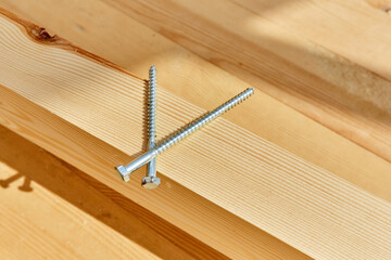 The screws lie on a wooden board