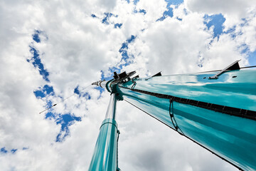 truck crane with outstretched boom on blue sky background