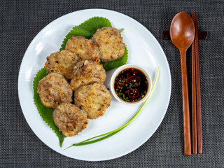 Korean food : Donjeonya(Donggeurangttaeng). A mixture of ground beef or pork and minced vegetables molded into round shapes, flour-coated, egg-battered, and pan-fried.