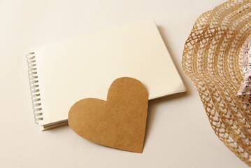 Hat, notebook and heart shape. Natural color design .İnvitation. Top view