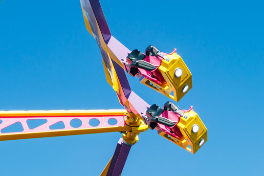 Extreme ride in motion in amusement park at sunny day