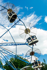 Ride carousel in motion in amusement park at sunny day