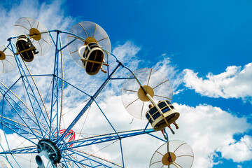 Ride carousel in motion in amusement park at sunny day