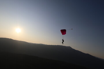 Skydivers over snowy mountains in Norway