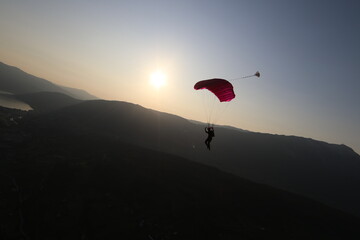 Skydivers over snowy mountains in Norway