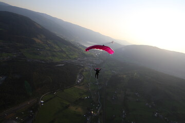 Skydivers over snowy mountains in Norway