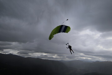 Skydivers over snowy mountains in Norway