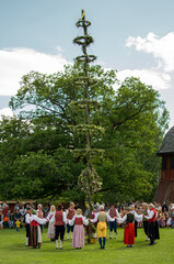 Raising of a midsummer pole duringa a traditional celebration of swedish midsummer in the small town of Skara