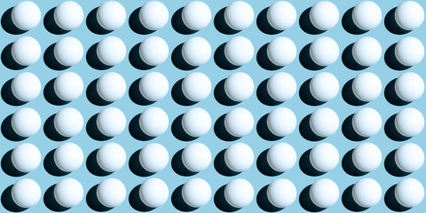 A pattern of white ping pong balls as spheres isolated on uniform blue background. Banner size.