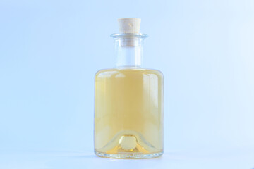 Essence of flowers on white background in beautiful glass Bottle