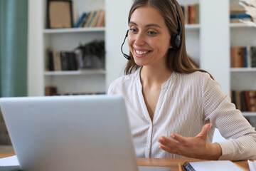 Female customer support operator with headset and smiling.