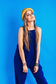 Attractive Woman In Blue Jumpsuit And Straw Hat