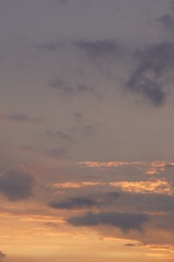 Beautiful evening blue sky at sunset with flaming bright light clouds. A warm summer evening at sunset.