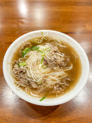 Beef noodle soup on wooden table