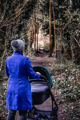 Mother walking with child around forest at Newstead Abbey
