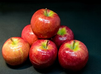 Fresh red apples isolated on dark background