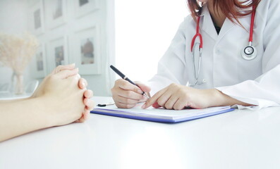 doctor writing on clipboard,Doctor's hand has pen and papers, Documents on lab desks, Doctor heals sick people, Doctor's office, Medical equipment and treatment concept, Hospital.