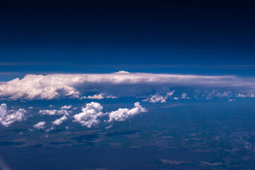 Fototapeta na wymiar Aerial view of the fantastic and curious clouds, View on an airplane,