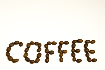 On white blank background coffee beans laid out word COFFEE