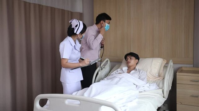 The image of doctors and nurses is examining the patients in the hospital.