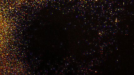 Sparkling gold glitter on a black background, magic abstract background. Round frame made of gold particles,