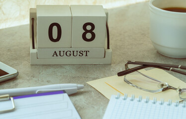 August 08, date on the calendar. Handmade wood cube with date month and day. planning for the day.
