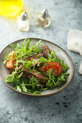 Arugula salad with grilled beef steak