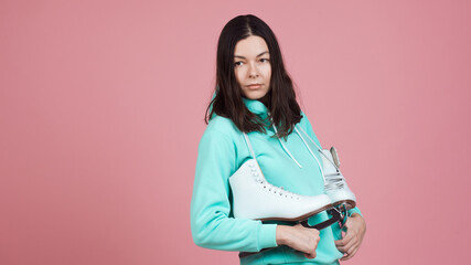 Figure skating for adults, Hobbies and a healthy lifestyle. A young woman in a bright sweatshirt...