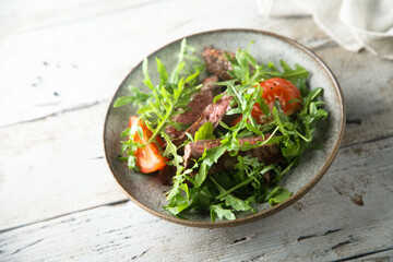 Arugula salad with grilled beef steak