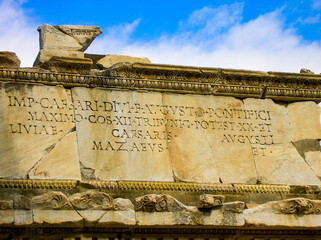 classical roman architecture with latin letters writing and words describing Caesars triumph