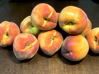 Fresh red peaches on dark brown wooden table
