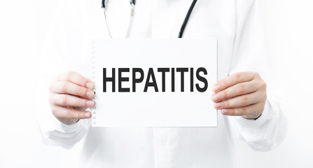 Hepatitis word on the sheet in the hands of the doctor. Treatment concept