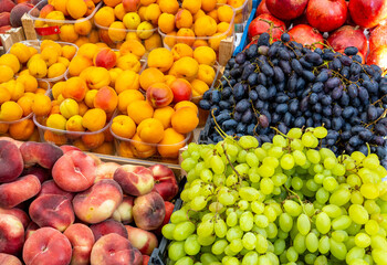 Grapes, peaches and plums for sale at a market