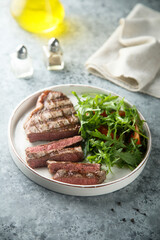 Grilled beef steak with green salad