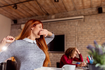 Woman yawning at work