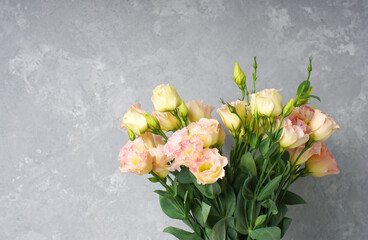 Eustoma flower (Lisianthus flower) with pink soft blooms on a decorative stone background