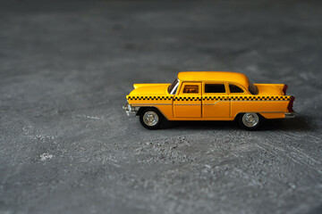Toy yellow taxi retro car close up