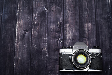 old photo camera on wooden background