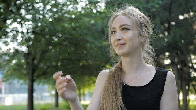 Beautiful blonde girl is sitting in wheelchair and having fun by playing and throwing plate