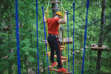 male climber rope park, outdoor activity training, guy, man extreme weekend in the forest