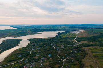 Aerial view of the picturesque landscape of land, trees, sky reflected in to the water. Go into the wild. Discover earth places.