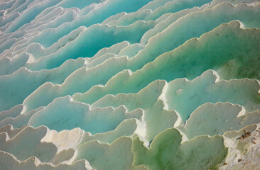 Fototapeta premium travertine terrace ripple salt deposits with blue pools in pamukkale turkey