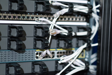 Hosting platform for modern Internet resources. Rack with server data storage equipment. Many network cables are connected to the data center equipment