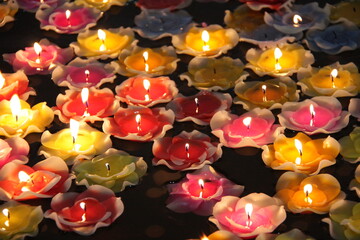 background burning candles in flower shape floating in the water.worship for buddha in thailand.