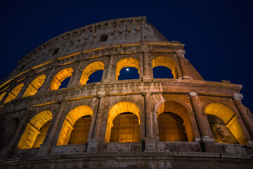 The monumental Colosseum at night, the largest oval Amphitheatre built by the Flavian dynasty in the centre of Rome, just east of the Roman Forum, an iconic symbol of the Roman Empire, Rome, Italy.