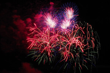 Flashes of fireworks against the dark sky. Salute.