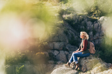 Woman with backpack hiking in the mountains