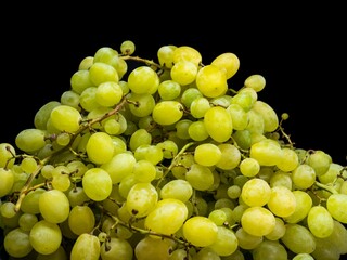 Sweet green grapes on a black background