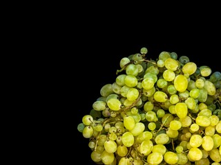 Sweet green grapes on a black background